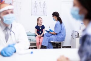 pediatric nurse talking to a child in hospital