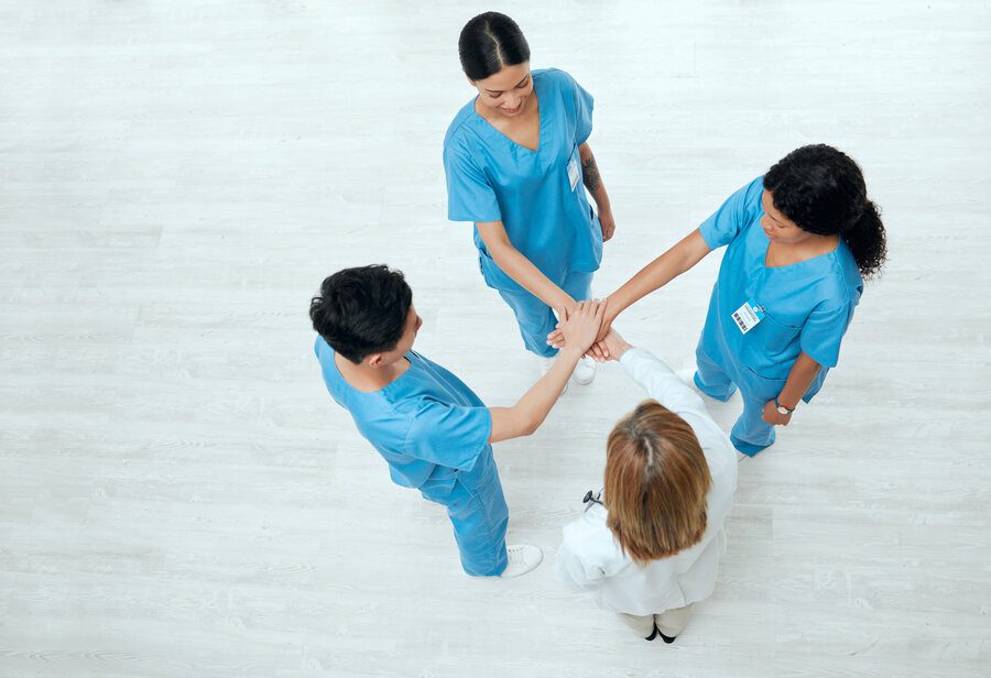 Group of medical practitioners joining hands